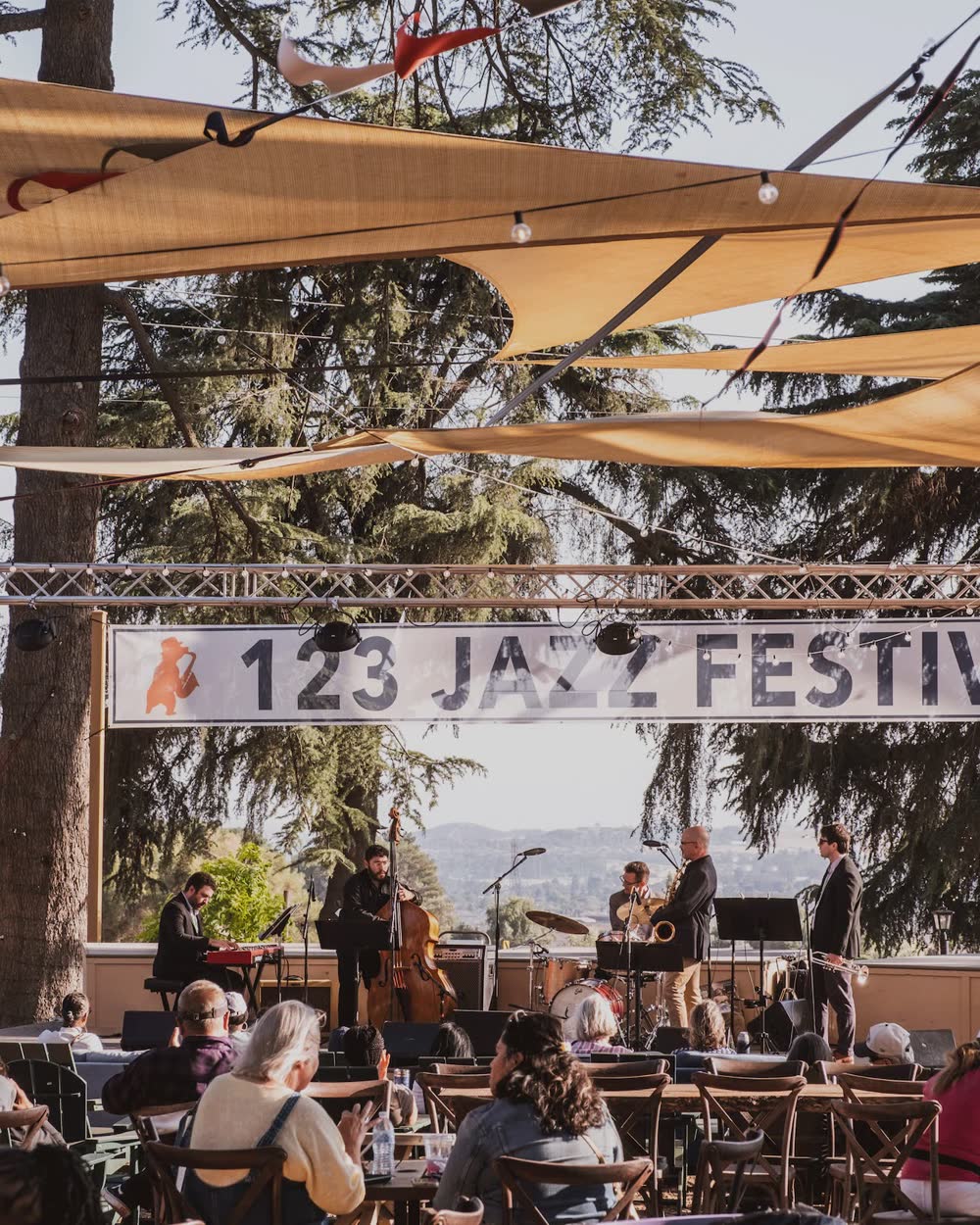 A jazz band playing under shade sails