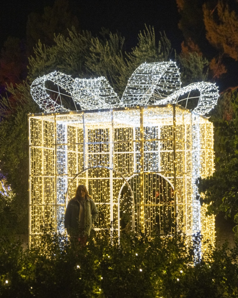 Walk-through light sculpture shaped like a giant wrapped gift